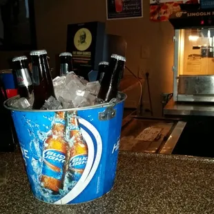 a bucket full of beer bottles