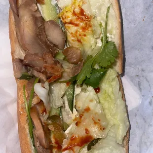 a sub sandwich with lettuce and mushrooms