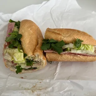 a sub sandwich with meat and lettuce