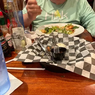 a man sitting at a table with a plate of food