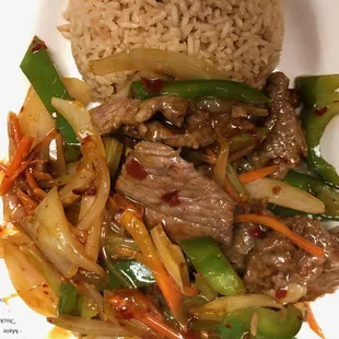 a plate of stir fried beef and vegetables