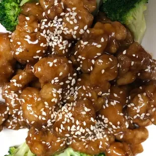 a plate of chinese food with broccoli