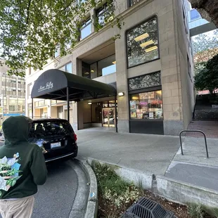 Front of the building, Lucky Penny is in to the right. Free parking on street or paid in the lot across the street.