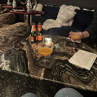 a person sitting at a table with a glass of beer