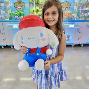 Little girl with her upgraded prize at Lucky Puppy Claw Machine Arcade!