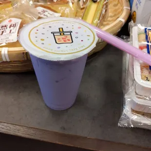 a purple cup with a straw