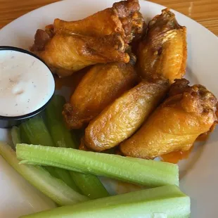 a plate of chicken wings and celery