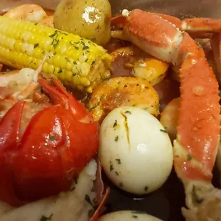 crab legs, potatoes, carrots, and corn
