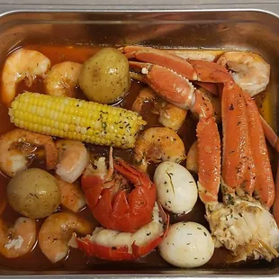 shrimp, crab legs, potatoes, and corn