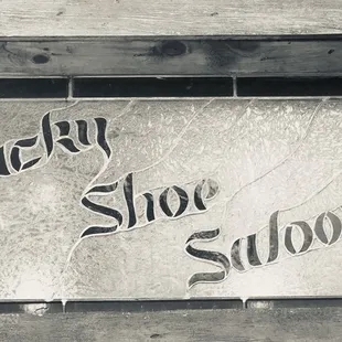 a sign for lucky shoe saloon