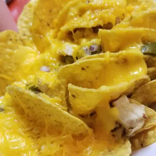 Chicken and cheese nachos with onions and jalapenos