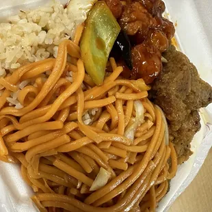noodles, meat, and vegetables in a styrofoam container
