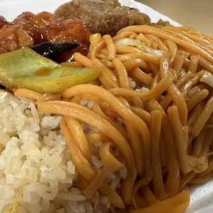 a plate of noodles and meat