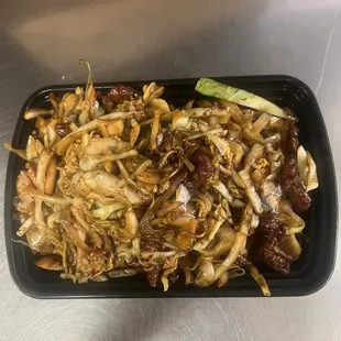 a tray of noodles with meat and vegetables