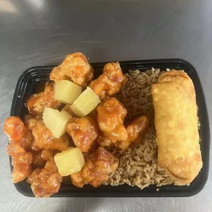a tray of food with rice and chicken