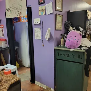 a trashcan with a stuffed animal on top of it