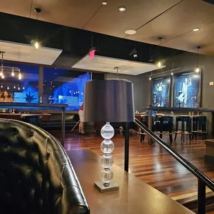 the inside of a restaurant with a bar in the background