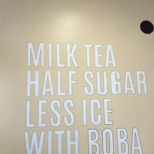  sign for milk tea, half sugar, and less ice with boba