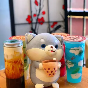 a stuffed animal holding a cup of tea