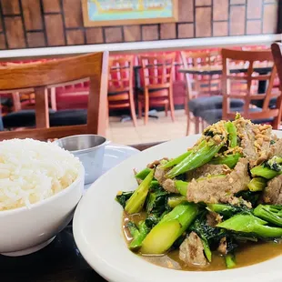 a bowl of rice and a plate of meat and vegetables