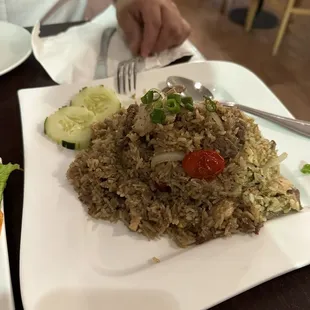 a plate of fried rice and vegetables