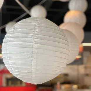 white paper lanterns hanging from the ceiling