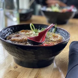 a bowl of ramen with chopsticks