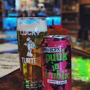 a beer and a can on a bar