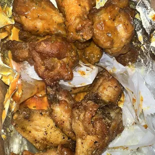 chicken wings in a tin foil container