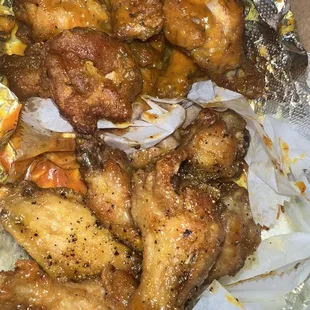 a plate of chicken wings on foil