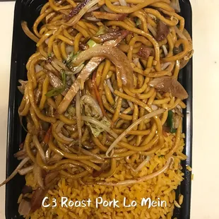 noodles and meat in a black container