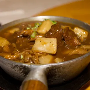 a bowl of stew on a plate