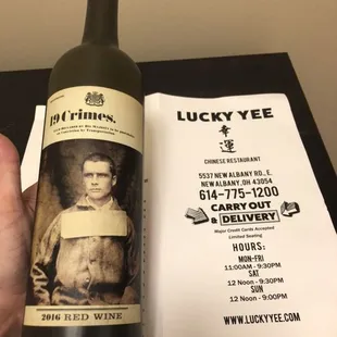 a hand holding a bottle of wine