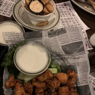 a plate of fried chicken wings and dipping sauce