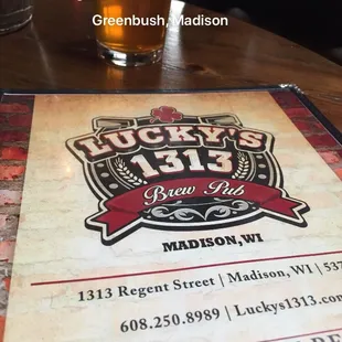 a menu and a glass of beer