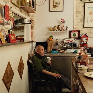 a man sitting in a kitchen