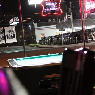 a pool table and neon signs