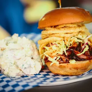 Pulled Pork Sandwich made with housemade BBQ, coleslaw and crispy onions.