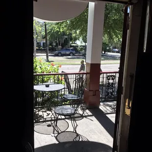 a patio with tables and chairs