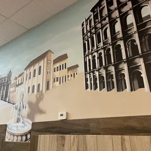 a mural of buildings and a clock