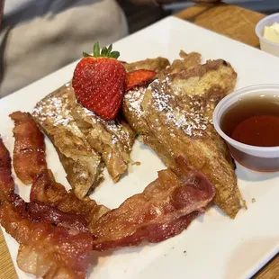 Breakfast: Lucky's French toast, 2 bacon strips, (warm butter?), syrup, strawberries....1? Powdered sugar. $8.95 Tastes very eggy.