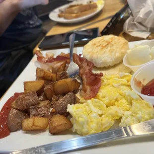 Lucky Two w/ scrambled eggs, bacon strips, biscuit and potatoes $9.95