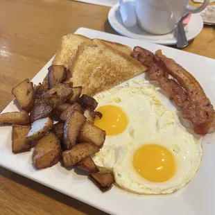 Lucky Two w/ sunny side up eggs, bacon strips, biscuits?!?! and potatoes $9.95 (my picture looks better than it tastes)!