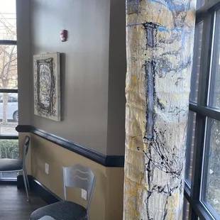 a table and chairs in front of a window