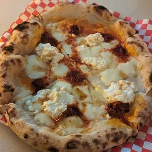 Monalizza Pizza - mozzarella, ricotta, spicy 'nduja sausage, roasted tomatoes and Mike's hot honey.