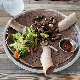 Zilzil Tibs served over injera with awaze sauce