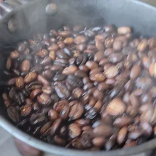 Showing us the coffee beans being roasted to order