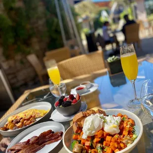 Breakfast hash, omelette, side of bacon and fresh fruits. Mimosa!
