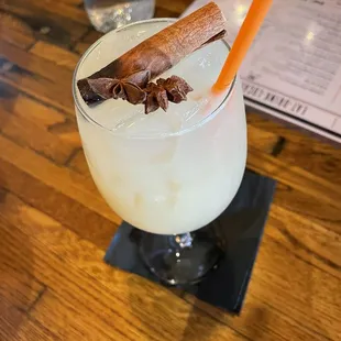 a cocktail with a cinnamon stick
