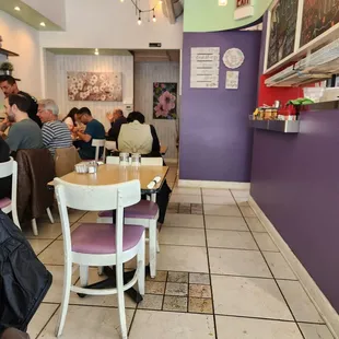 people sitting at tables in a restaurant
